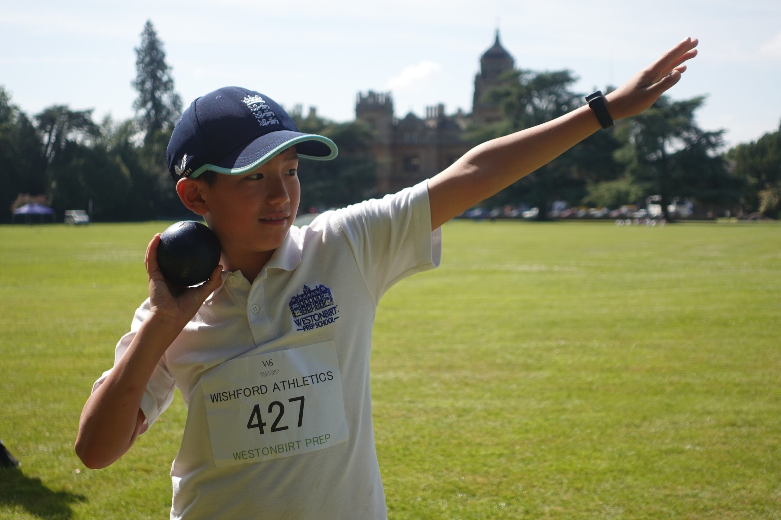 Prep school pupil participating in shot put