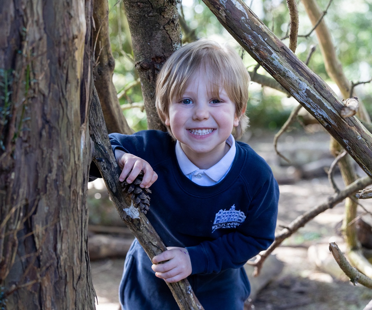 A Reception pupil takes part in a Forest School lesson at Westonbirt Prep School