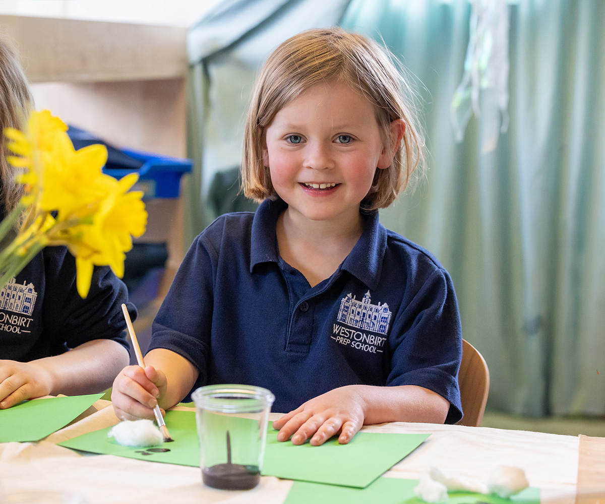 A Reception pupil takes part in an art lesson at Westonbirt Prep School