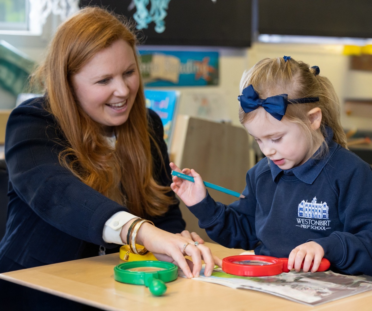 A Reception teacher works with a pupil at Westonbirt Prep School