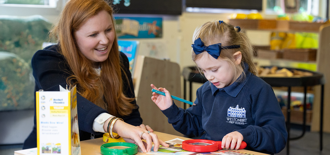 A Reception teacher works with a pupil at Westonbirt Prep School